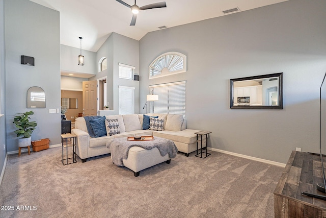 carpeted living room featuring ceiling fan and high vaulted ceiling