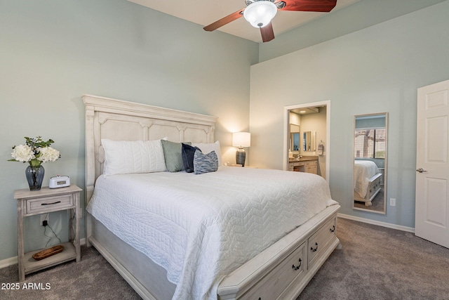 carpeted bedroom featuring ceiling fan, connected bathroom, and a high ceiling