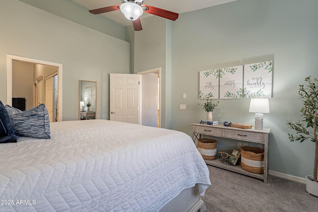 bedroom featuring ceiling fan, a high ceiling, and carpet