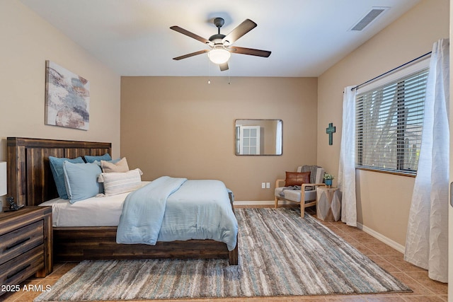 tiled bedroom featuring ceiling fan