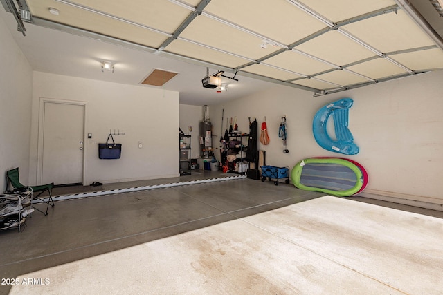 garage featuring water heater and a garage door opener