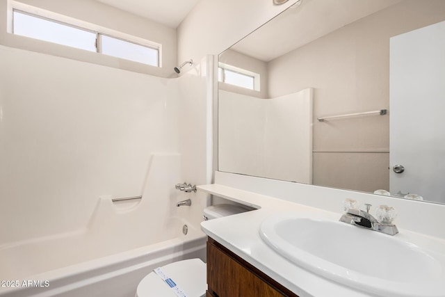 full bath featuring vanity, toilet, and washtub / shower combination