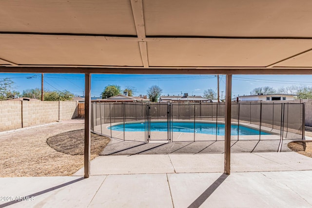 view of swimming pool featuring a patio area, a fenced in pool, and a fenced backyard