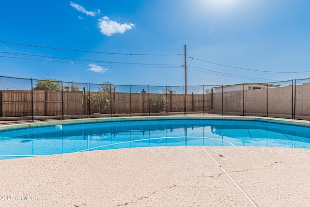 view of swimming pool featuring a fenced in pool and fence