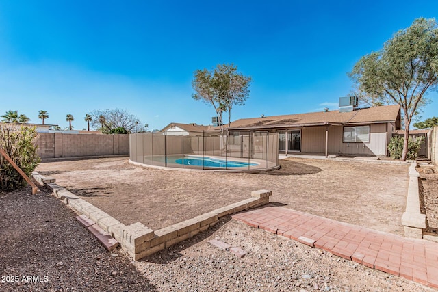 view of yard with a patio area, a fenced backyard, a fenced in pool, and central AC