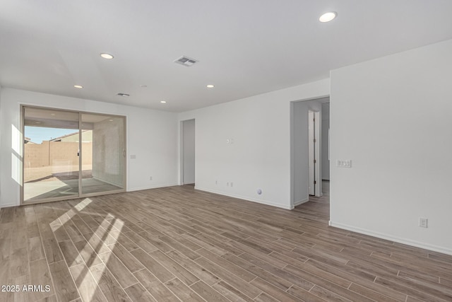 spare room featuring wood-type flooring