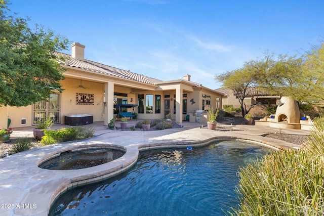 pool featuring a patio area, an in ground hot tub, ceiling fan, and an outdoor fireplace