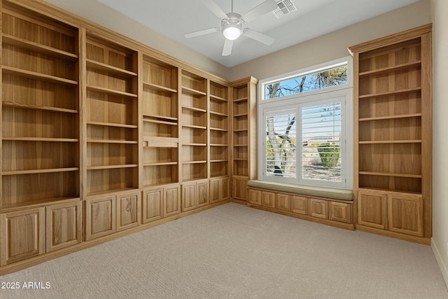 unfurnished room featuring a ceiling fan, visible vents, and light colored carpet