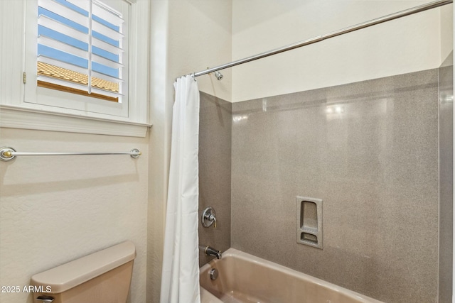 bathroom with shower / bath combo and toilet