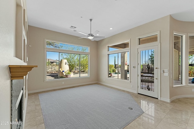 unfurnished living room with a ceiling fan, recessed lighting, visible vents, and baseboards