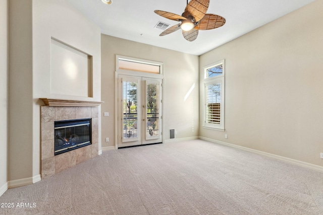 unfurnished living room with carpet floors, visible vents, and baseboards