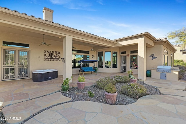 view of patio / terrace with ceiling fan, a hot tub, and area for grilling