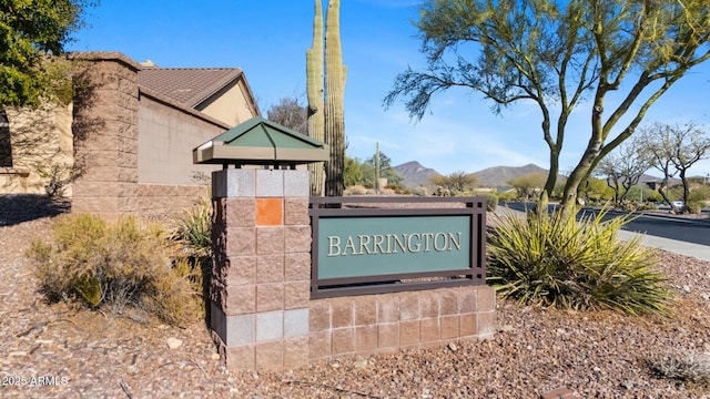 community / neighborhood sign with a mountain view