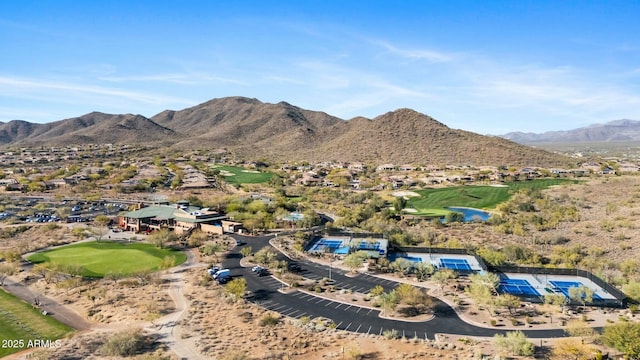 drone / aerial view with view of golf course and a mountain view