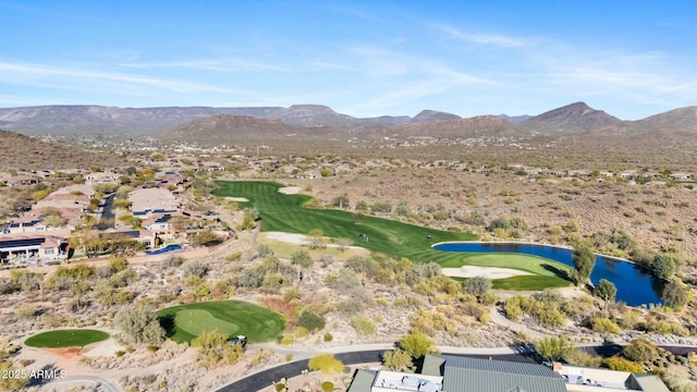 birds eye view of property with view of golf course and a water and mountain view