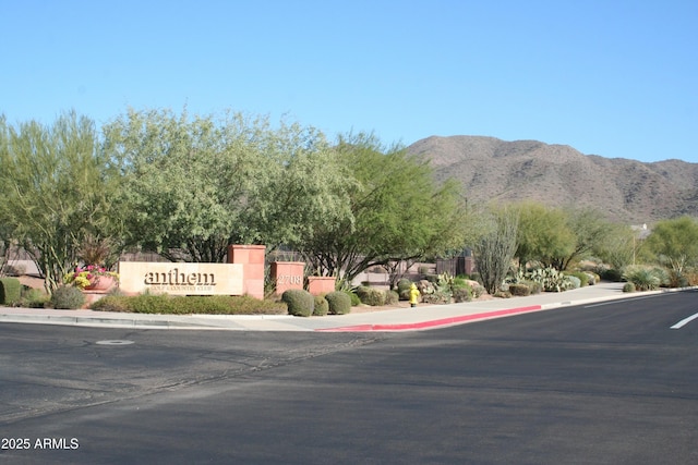 view of road with curbs, sidewalks, and a mountain view