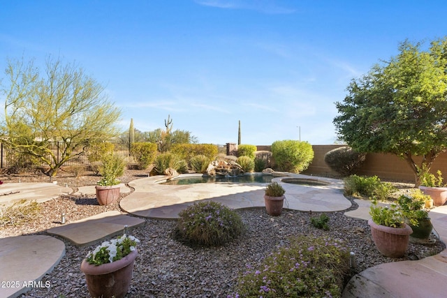 view of yard featuring a fenced in pool, a patio area, a fenced backyard, and an in ground hot tub