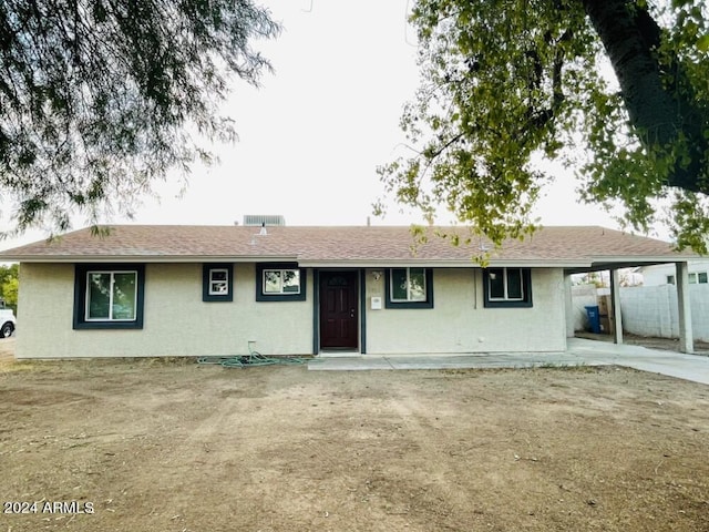 ranch-style home featuring a carport