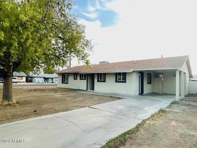 ranch-style home with a carport