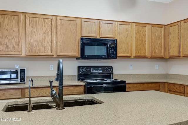 kitchen with black appliances, light countertops, and a sink