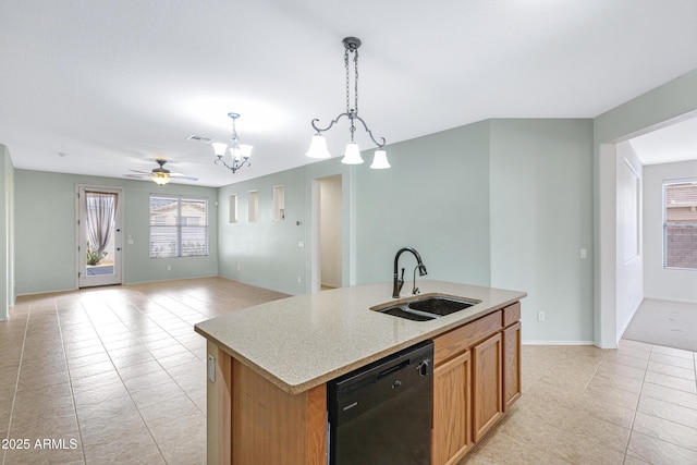 kitchen featuring a sink, visible vents, light countertops, hanging light fixtures, and dishwasher