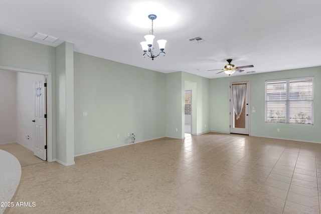 empty room featuring baseboards, visible vents, and ceiling fan with notable chandelier