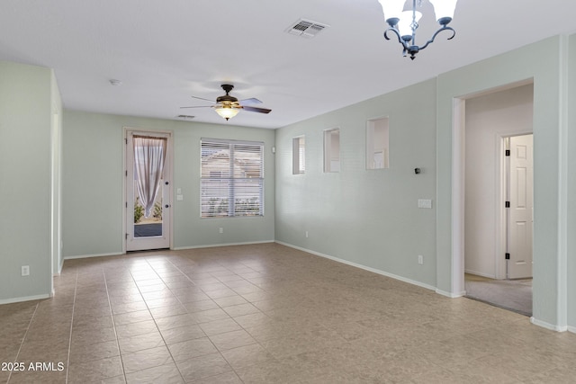 spare room with light tile patterned flooring, visible vents, baseboards, and ceiling fan with notable chandelier