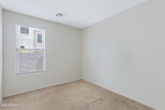 empty room with light carpet, baseboards, and visible vents