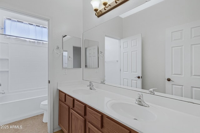 full bath featuring double vanity, tile patterned flooring, a sink, and toilet