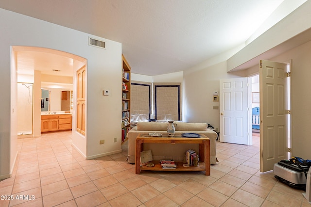 17038 E Rand Dr, Fountain Hills, AZ 85268 - living area with arched walkways, baseboards, visible vents, and light tile patterned floors