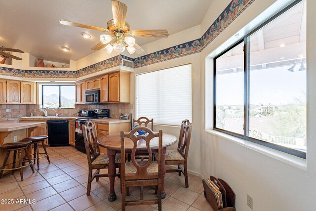 17038 E Rand Dr, Fountain Hills, AZ 85268 - dining space with light tile patterned flooring, vaulted ceiling, baseboards, visible vents, and ceiling fan