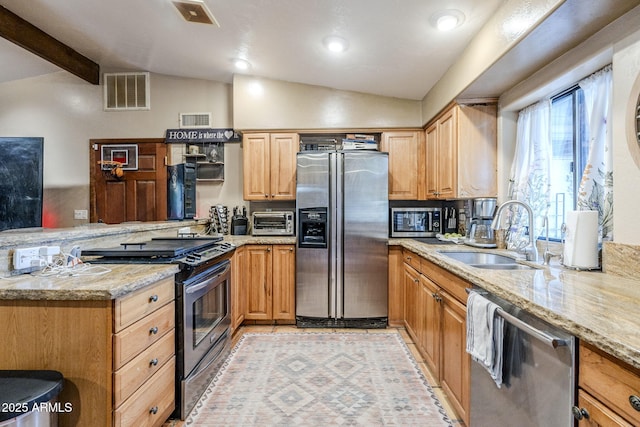 kitchen featuring lofted ceiling with beams, stainless steel appliances, light stone countertops, and sink