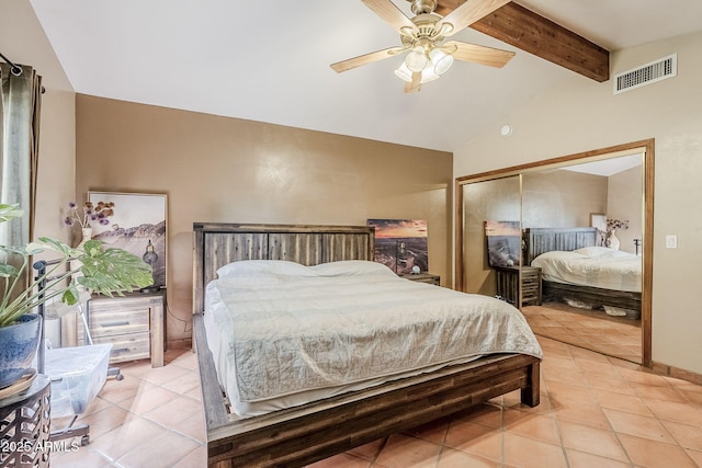 bedroom featuring ceiling fan, lofted ceiling with beams, a closet, and light tile patterned floors