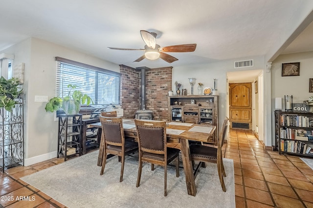 tiled dining area featuring ceiling fan