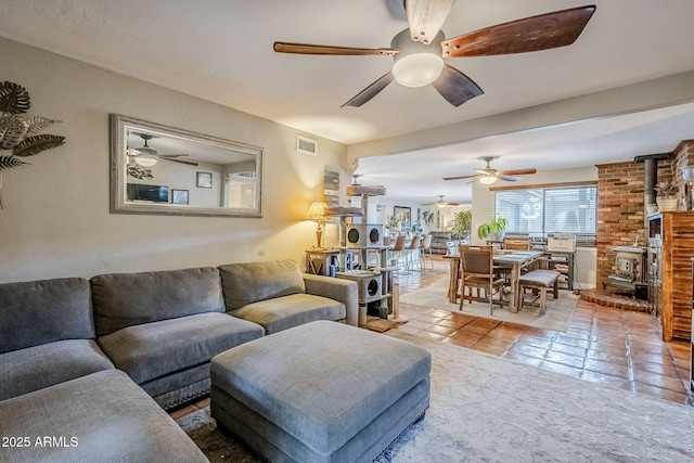 tiled living room featuring a wood stove