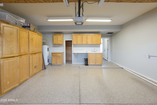 garage with visible vents, baseboards, a garage door opener, electric water heater, and a sink