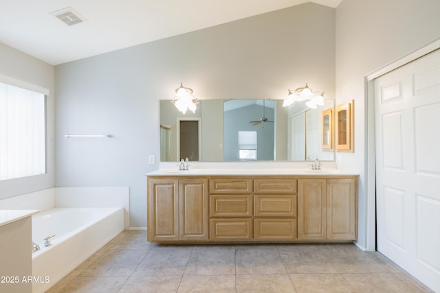 full bath featuring tile patterned flooring, visible vents, a sink, and a bath