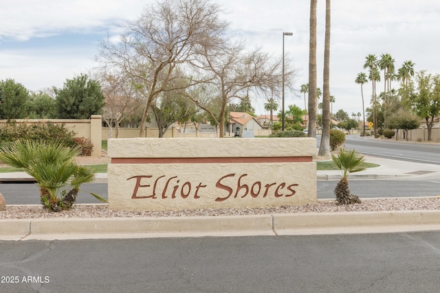 community / neighborhood sign with fence