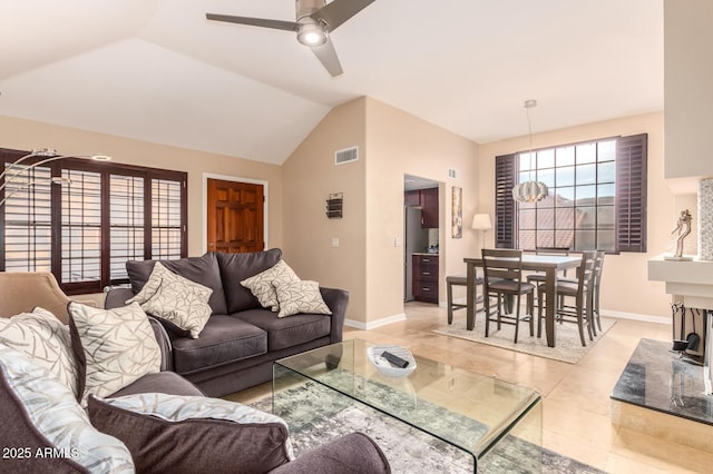 living area featuring a ceiling fan, lofted ceiling, visible vents, and baseboards