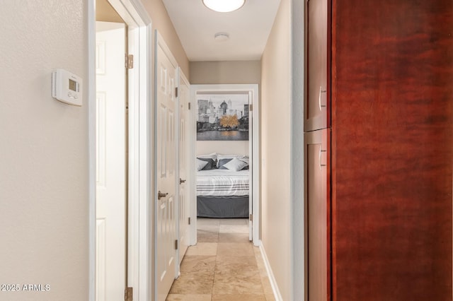 hallway featuring baseboards