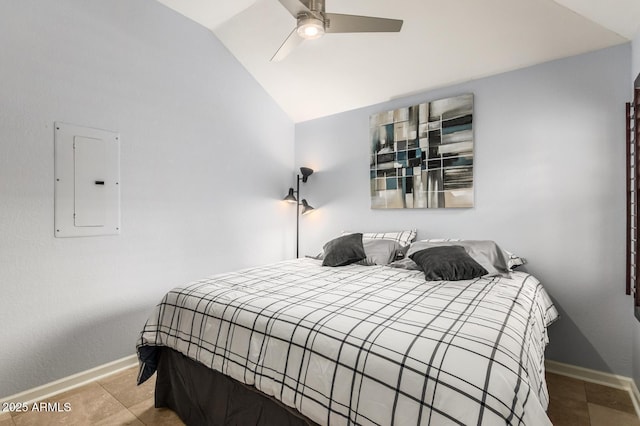 bedroom featuring a ceiling fan, light tile patterned flooring, vaulted ceiling, electric panel, and baseboards