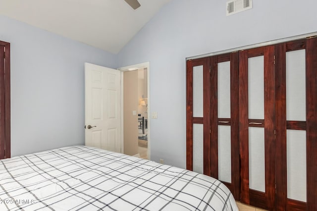 bedroom with vaulted ceiling, ceiling fan, a closet, and visible vents