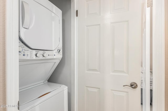 laundry room featuring laundry area and stacked washer and clothes dryer