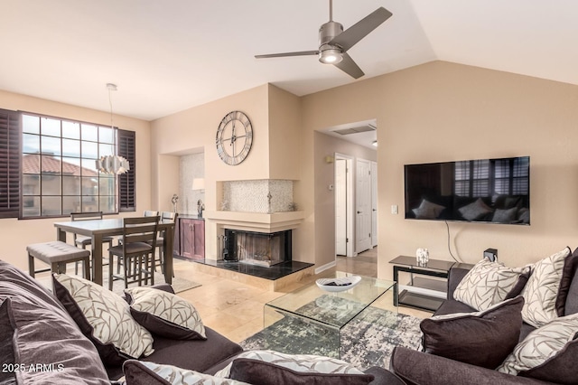 tiled living room with a tile fireplace, visible vents, lofted ceiling, and ceiling fan with notable chandelier