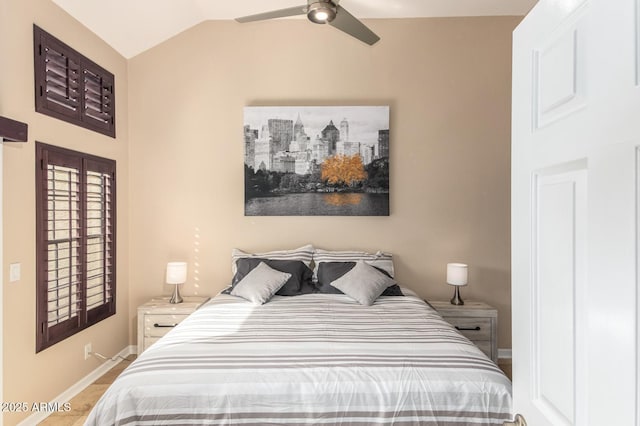 bedroom with lofted ceiling, baseboards, and a ceiling fan