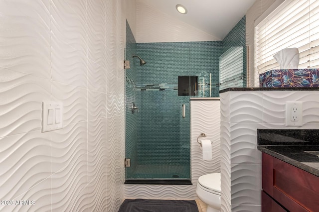 full bath featuring a stall shower, vaulted ceiling, vanity, and toilet