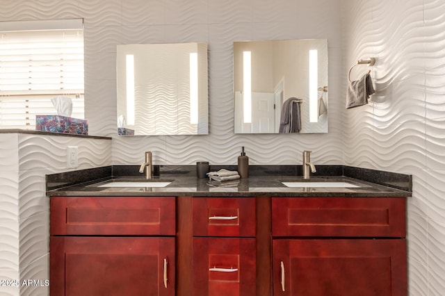 full bathroom featuring double vanity and a sink