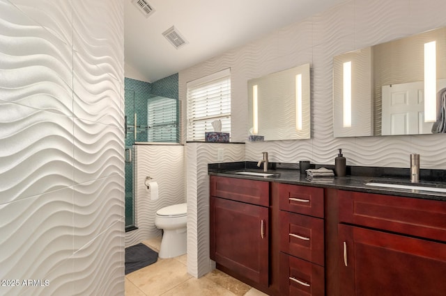 bathroom with double vanity, visible vents, a sink, and tile patterned floors