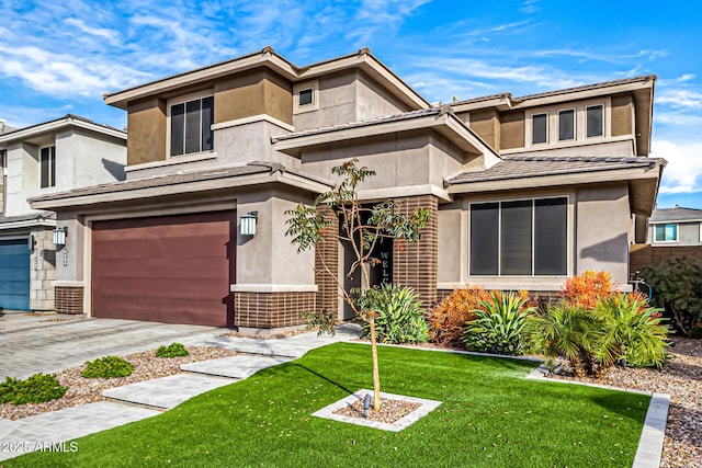 view of front of home with a garage and a front lawn