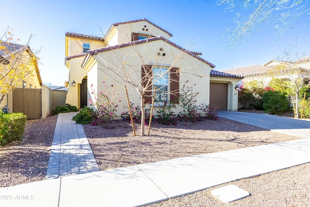 mediterranean / spanish-style home with a garage